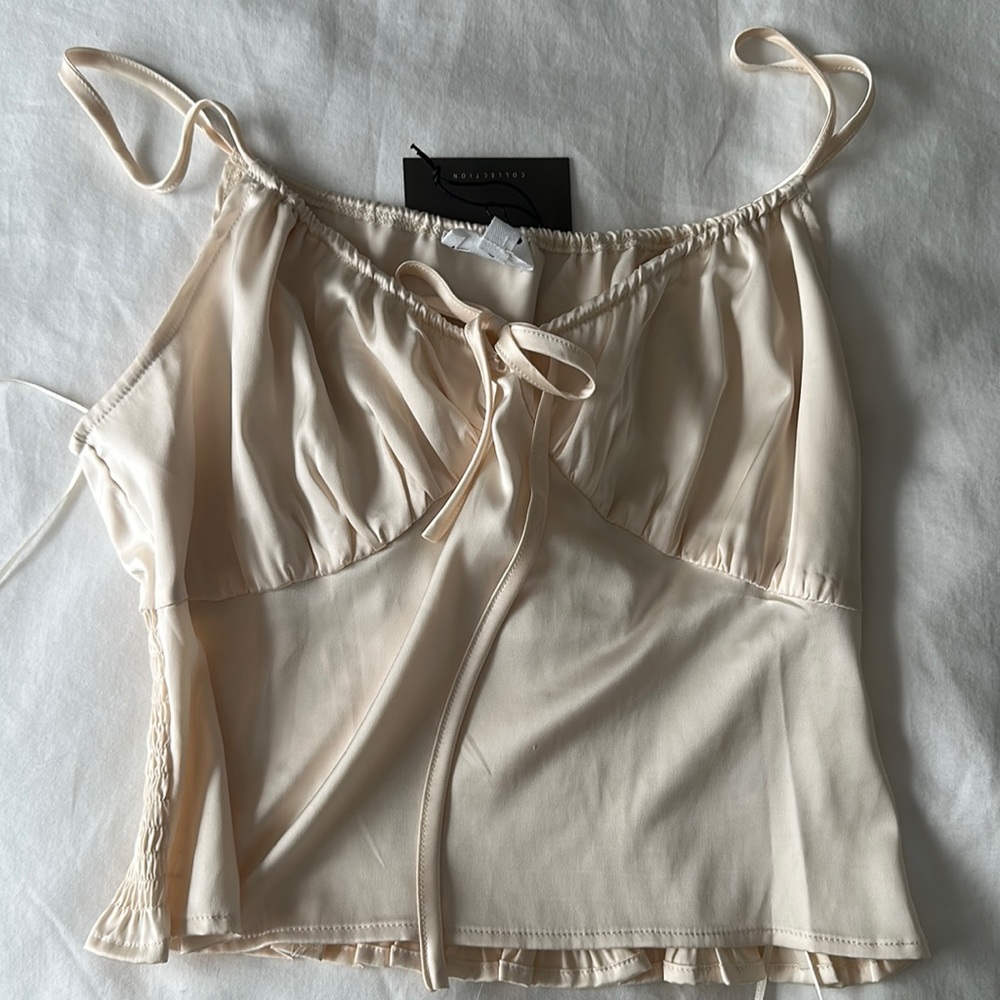Never worn babydoll top. Draw string/bow tie around cleavage for perfect fit